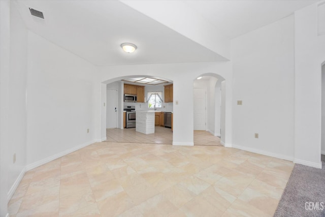 5820 Siena Ln, Bakersfield, CA 93308 - unfurnished living room featuring arched walkways, baseboards, and light tile patterned floors