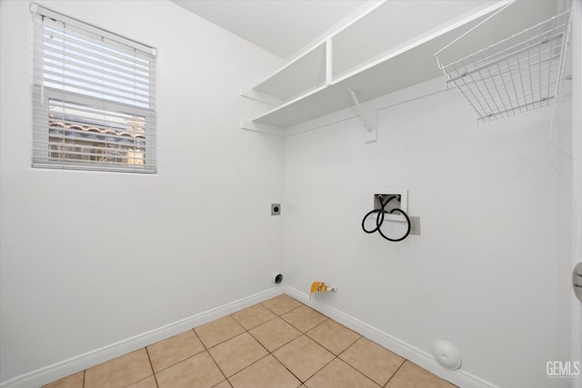 5820 Siena Ln, Bakersfield, CA 93308 - laundry room featuring hookup for a gas dryer, hookup for a washing machine, baseboards, electric dryer hookup, and light tile patterned floors
