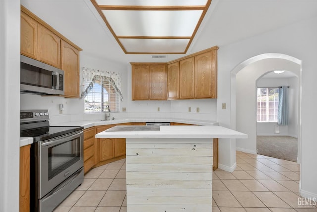 5820 Siena Ln, Bakersfield, CA 93308 - kitchen with appliances with stainless steel finishes, arched walkways, light countertops, and plenty of natural light