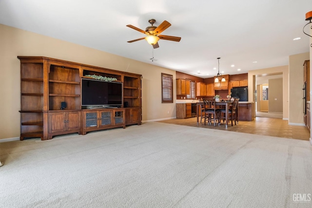 living room featuring ceiling fan and light carpet