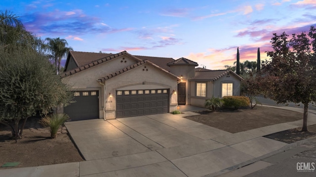 mediterranean / spanish home featuring a garage