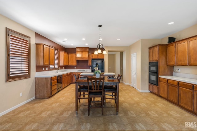 kitchen with pendant lighting, sink, and black appliances