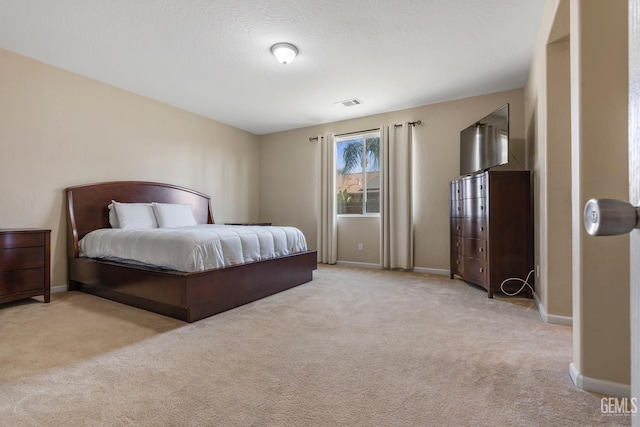 bedroom with light colored carpet