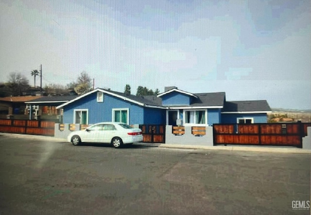 ranch-style house with fence