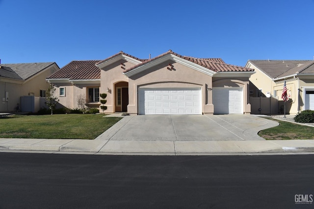 mediterranean / spanish-style house with a front yard, stucco siding, concrete driveway, a garage, and a tile roof