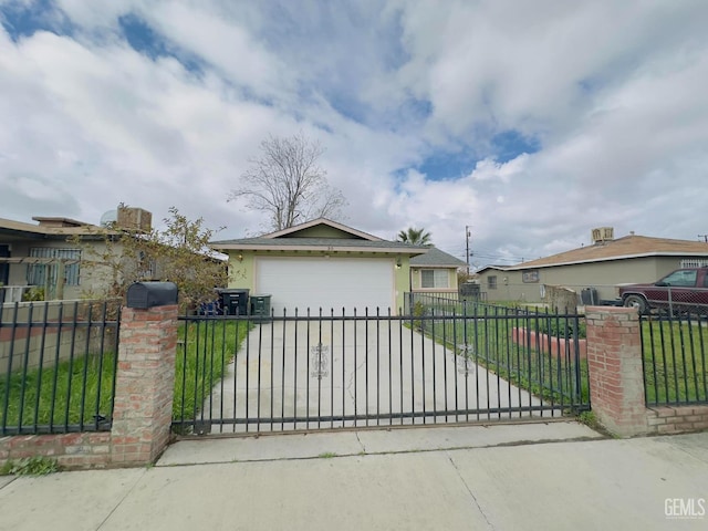 view of front of property featuring a gate, driveway, and a fenced front yard