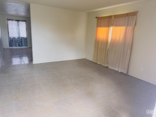 empty room with tile patterned flooring