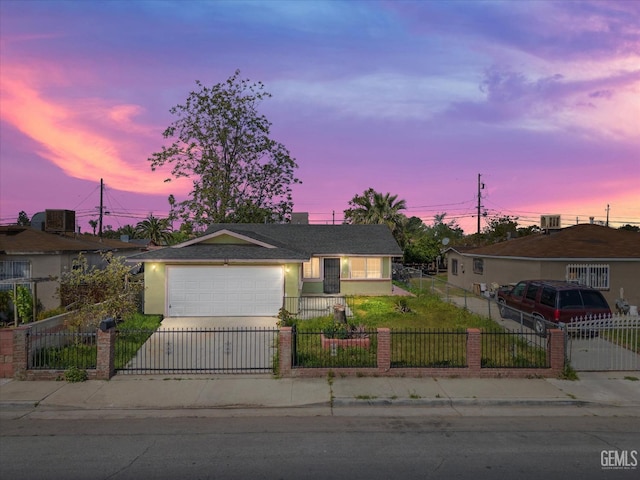 ranch-style house featuring an attached garage, a fenced front yard, stucco siding, and concrete driveway