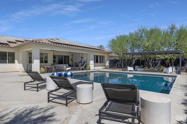 view of pool with a patio and ceiling fan