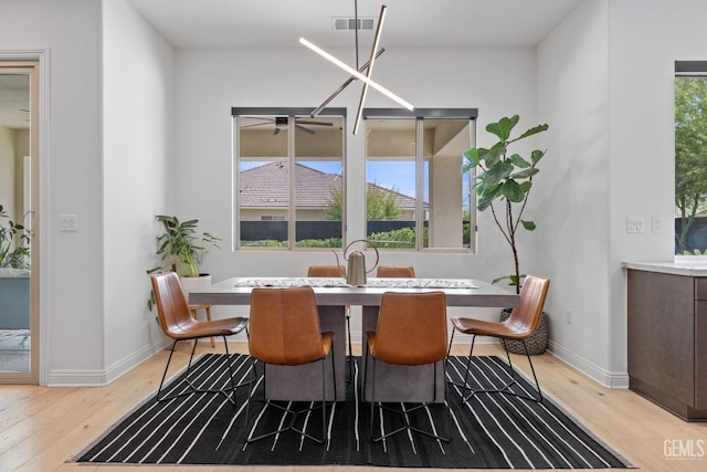 dining space with light hardwood / wood-style floors