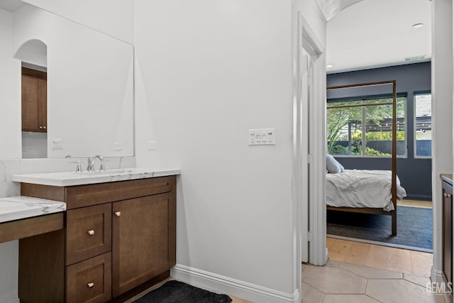 bathroom featuring tile patterned flooring and vanity