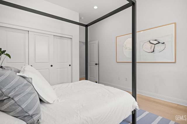 bedroom featuring a closet and light wood-type flooring