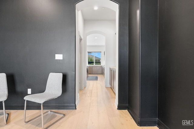 corridor with light hardwood / wood-style flooring