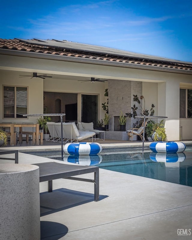 view of pool featuring ceiling fan and a patio area