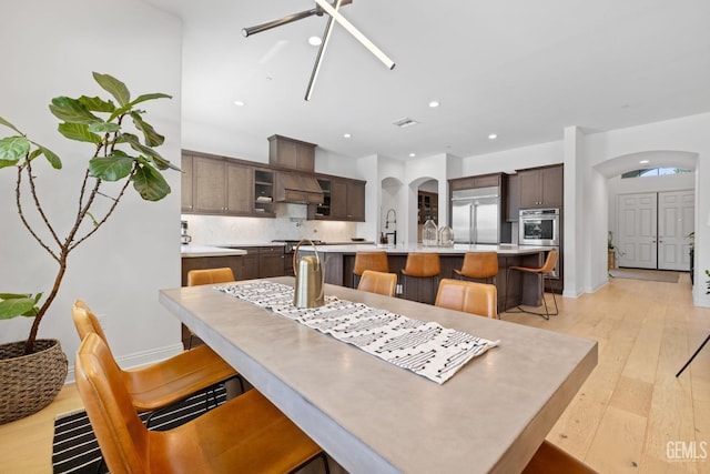 dining area with light hardwood / wood-style flooring and sink