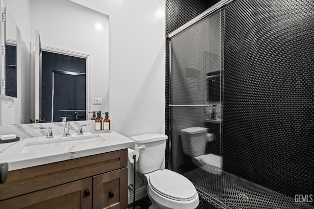 bathroom featuring vanity, toilet, and walk in shower