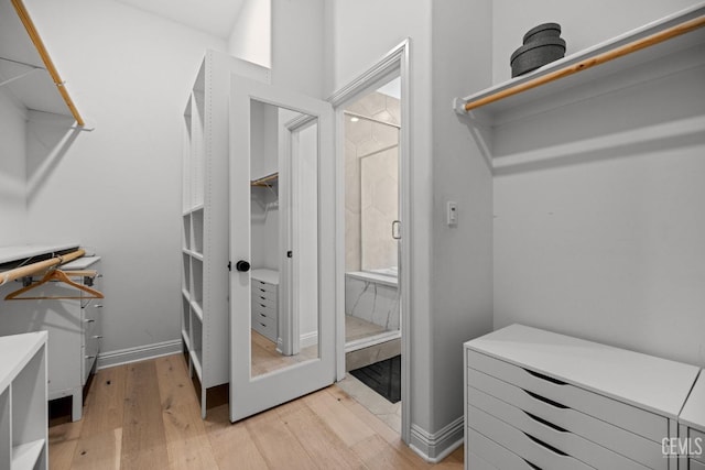 spacious closet with light hardwood / wood-style floors