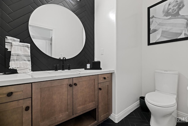 bathroom featuring tile patterned flooring, vanity, and toilet