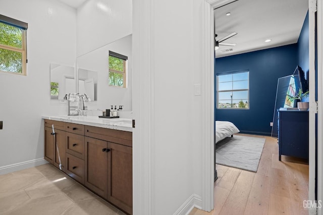 bathroom with ceiling fan, vanity, and hardwood / wood-style flooring