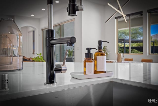 room details with light stone countertops and sink