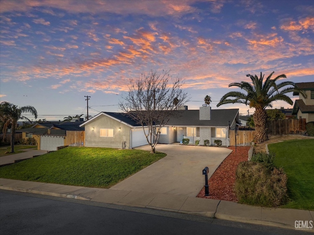 single story home with a yard and a garage