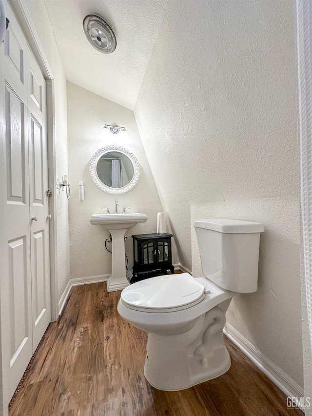 2305 Askin Ct, Pine Mountain Club, CA 93222 - half bathroom with lofted ceiling, toilet, wood finished floors, and baseboards