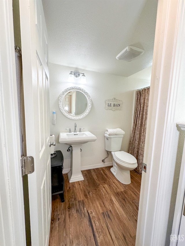 2305 Askin Ct, Pine Mountain Club, CA 93222 - bathroom with toilet, wood finished floors, a textured ceiling, and baseboards