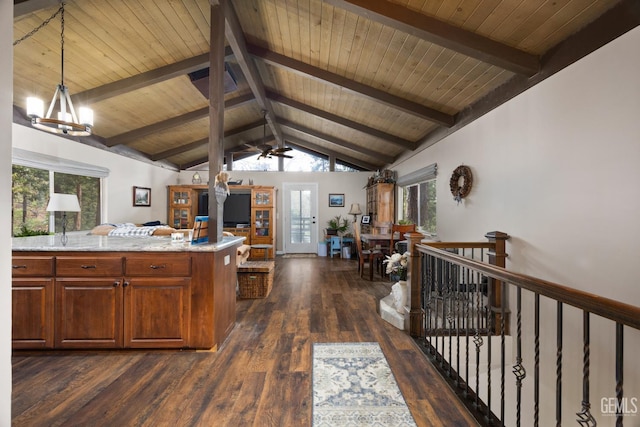 kitchen featuring dark hardwood / wood-style floors, decorative light fixtures, vaulted ceiling with beams, light stone counters, and wooden ceiling