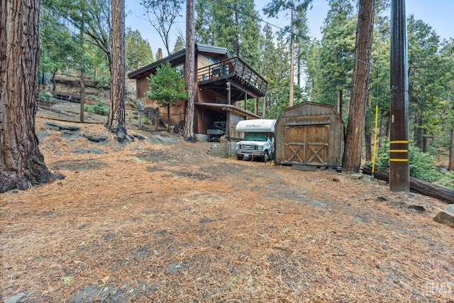 view of yard featuring a deck and a shed