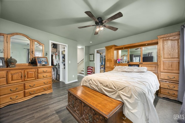 bedroom with dark hardwood / wood-style floors, ceiling fan, a spacious closet, and a closet