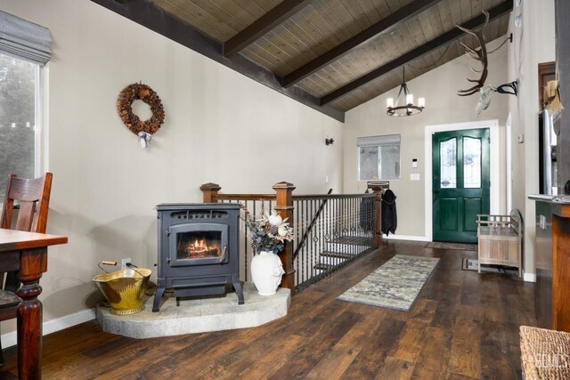 foyer entrance featuring dark wood-type flooring, a notable chandelier, wood ceiling, and vaulted ceiling with beams