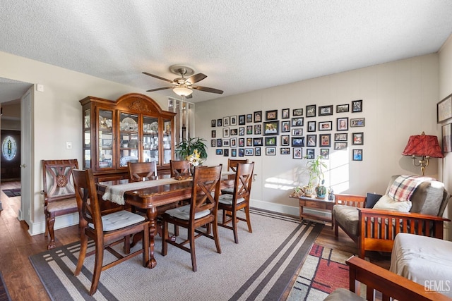 dining area featuring a textured ceiling, dark hardwood / wood-style floors, and ceiling fan