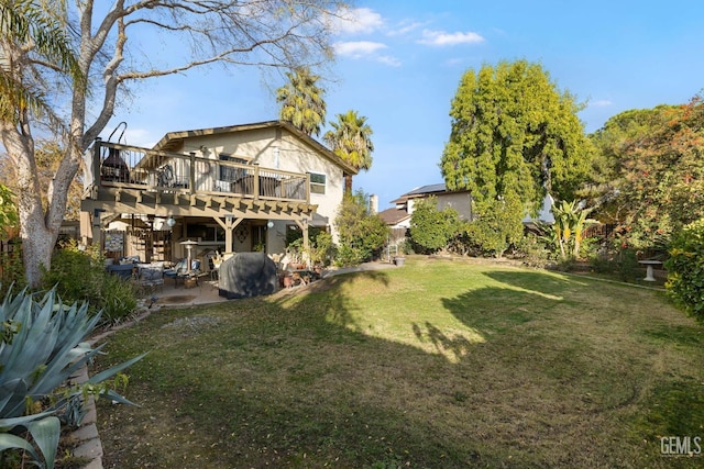 view of yard featuring a patio area and a wooden deck