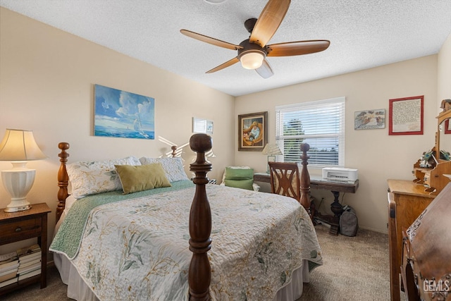 carpeted bedroom featuring a textured ceiling and ceiling fan