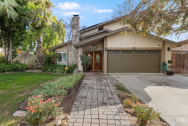 view of front of property with a garage and a front lawn