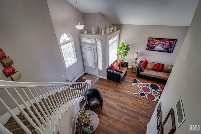 foyer entrance featuring dark hardwood / wood-style flooring and high vaulted ceiling