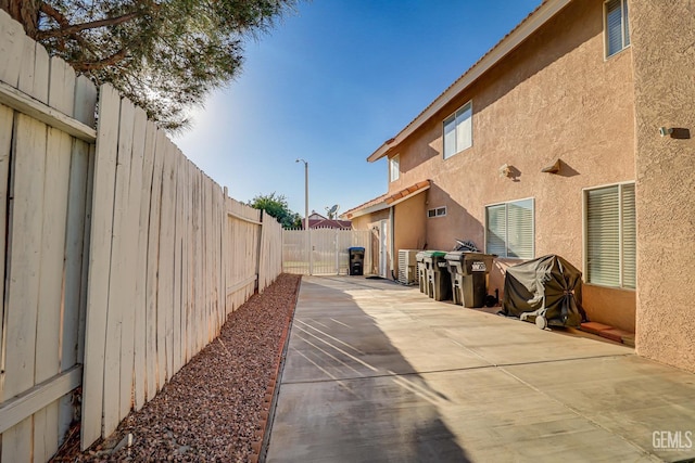 view of property exterior with a patio area