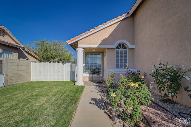 doorway to property with a yard