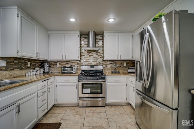 kitchen featuring white cabinets, wall chimney exhaust hood, light stone countertops, and appliances with stainless steel finishes