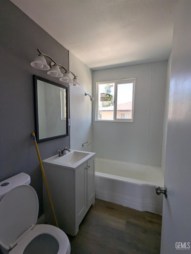 full bathroom with wood finished floors, toilet, and vanity