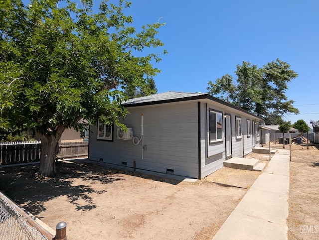 view of property exterior with fence and crawl space