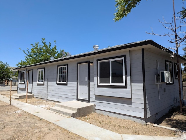 view of front of property featuring crawl space and ac unit