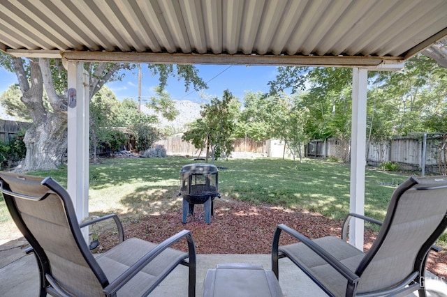 view of patio featuring a shed and a fire pit