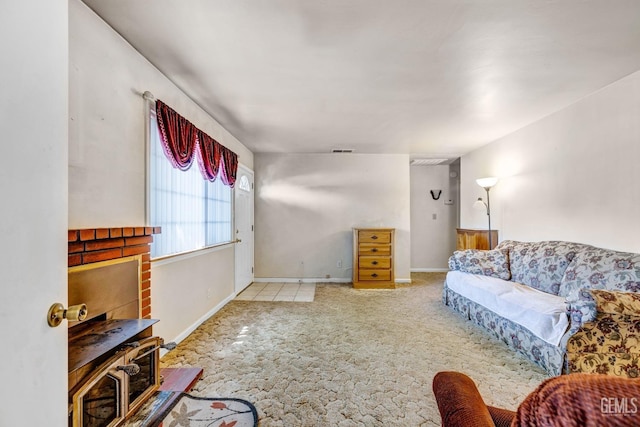 carpeted living room featuring a brick fireplace