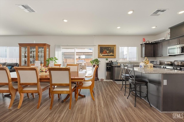 dining area with hardwood / wood-style flooring