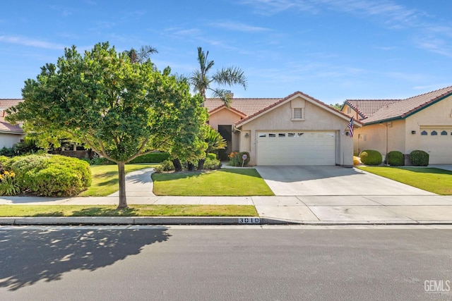3010 Tea Rose St, Bakersfield, CA 93311 - view of front of home featuring stucco siding, a tile roof, a garage, driveway, and a front lawn