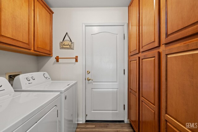 3010 Tea Rose St, Bakersfield, CA 93311 - washroom featuring washing machine and clothes dryer, cabinet space, and dark wood-style flooring