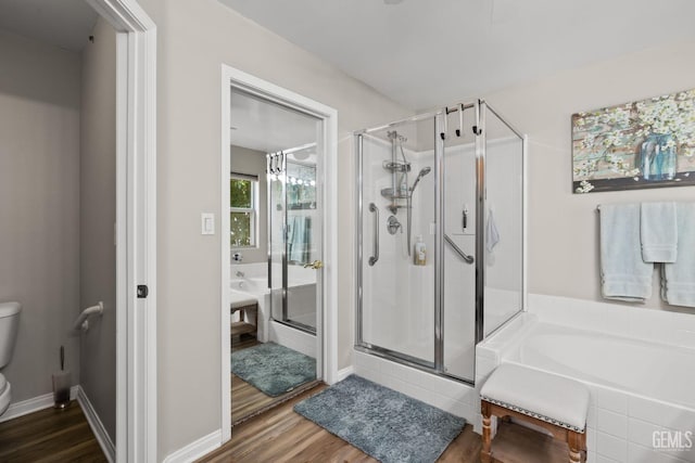 3010 Tea Rose St, Bakersfield, CA 93311 - bathroom with a bath, a shower stall, and wood finished floors