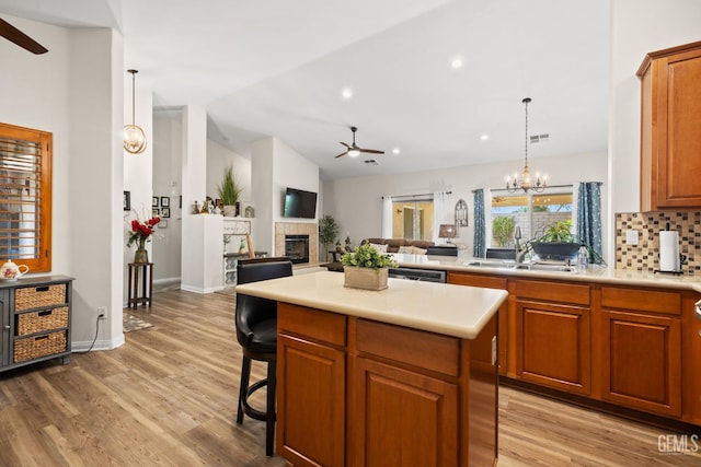 3010 Tea Rose St, Bakersfield, CA 93311 - kitchen with a ceiling fan, light wood-style flooring, light countertops, vaulted ceiling, and recessed lighting