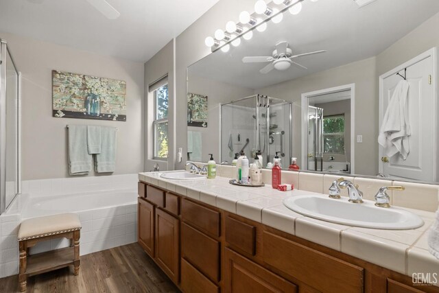 3010 Tea Rose St, Bakersfield, CA 93311 - bathroom featuring double vanity, a shower stall, a bath, ceiling fan, and wood finished floors
